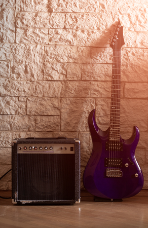 Guitar and amplifier on a stone backgroundの写真素材