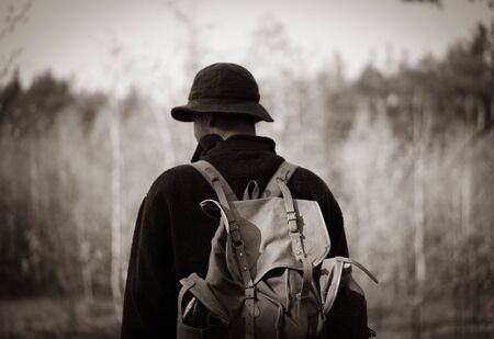 young guy with a vintage backpack in the forest. black and whiteの写真素材