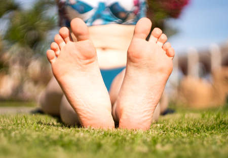 girls feet on the grass. yoga classes. close-up.の写真素材