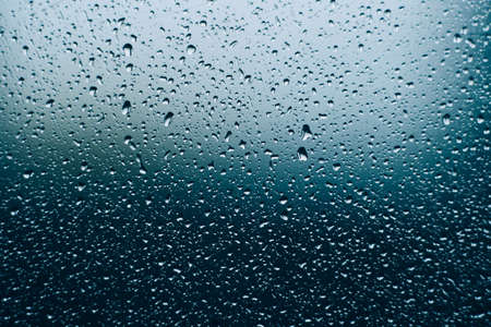 water droplets on glass. close-up. macro plan. blue background.の写真素材