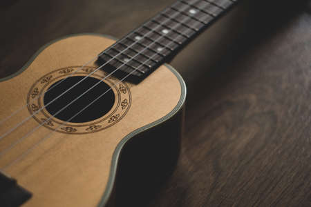 guitar ukulele on wooden background. close-up, macro.の写真素材