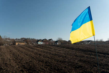 Ukrainian flag near the village. fighting. war.の写真素材