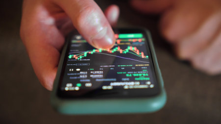 Hands with a mobile phone. Crypto trading in smartphone. close-up. Cryptocurrency trading.の写真素材