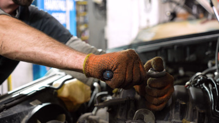 Auto mechanic repairs car engine. car service. close-up.の写真素材