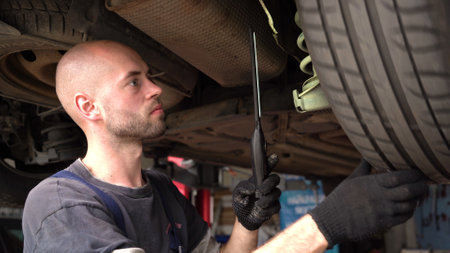 Car diagnostics. an auto mechanic inspects a car. auto repair shop. breaking. transmissionの写真素材