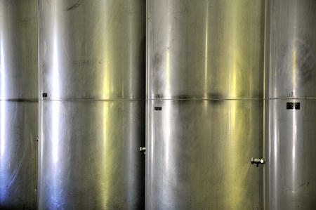 row of four stainless steel wine tanksの写真素材