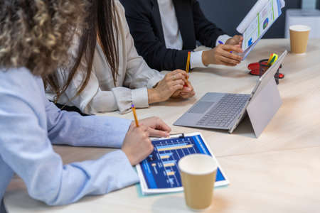 Happy business women sitting in a couch in the office and working together. Office concept.