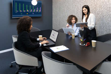 Happy business women sitting in a couch in the office and working together. Office concept.の写真素材