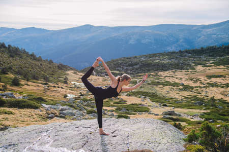 woman doing yoga poses in nature mountain peaceの写真素材