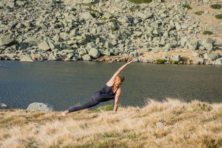 woman doing yoga poses in nature mountain peaceの写真素材