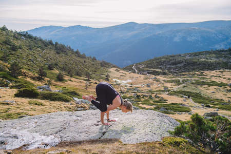 woman doing yoga poses in nature mountain peaceの写真素材
