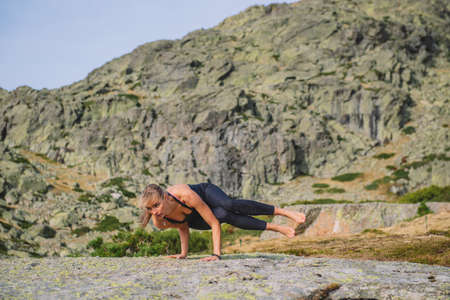 woman doing yoga poses in nature mountain peaceの写真素材