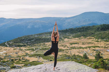 woman doing yoga poses in nature mountain peaceの写真素材