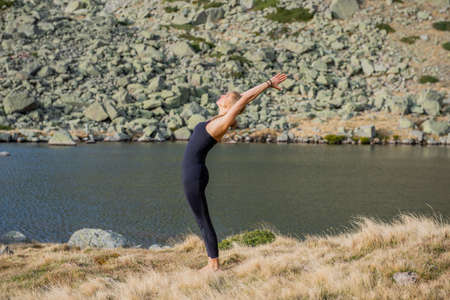 woman doing yoga poses in nature mountain peaceの写真素材