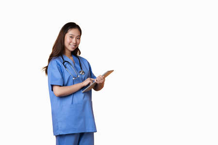 Studio photo with white background of a doctor pointing to a folder while smiling to the cameraの写真素材
