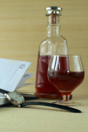 Notebook, glass of cognac and wrist watchesの写真素材