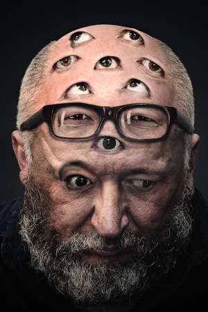 Man with a lot of eyes on his face. Photo manipulationの写真素材