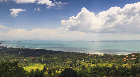 panoramic seascape with tropical forest valley, lagoon with boat pier and small village. calm ocean...