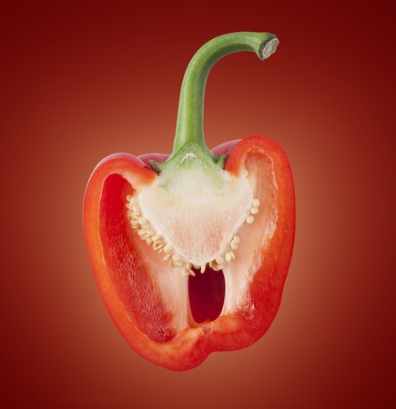 Sliced red bell pepper on a glowing colored background.の写真素材