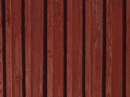 Scandinavian wooden boarded wall painted with traditional falu red paint.の写真素材