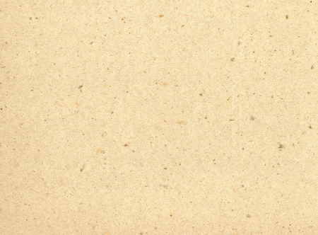 Particles of reused paper form a texture on this cream colored background.の写真素材