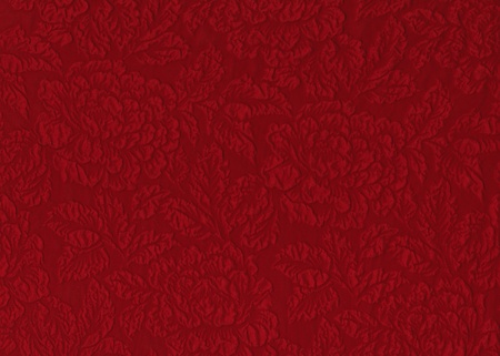 Red silk material with floral relief pattern.の写真素材