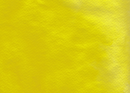 This a glowing yellow wash on textured watercolor paper.の写真素材