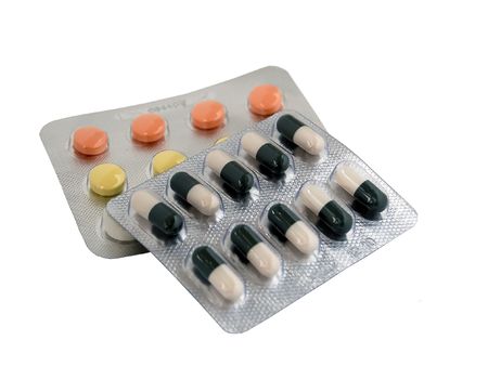 two sets of colored pills and tabletsの写真素材