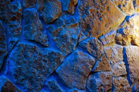 old-style wall of wild stones with decorative lightingの写真素材