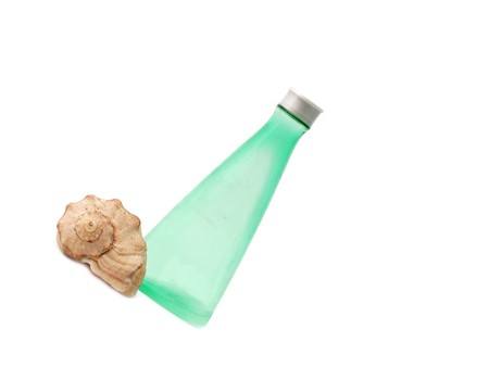 spa concept - green bottle for cosmetics and seashellの写真素材