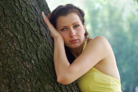 pretty blue-eyed brown-haired typical russian girl near treeの写真素材