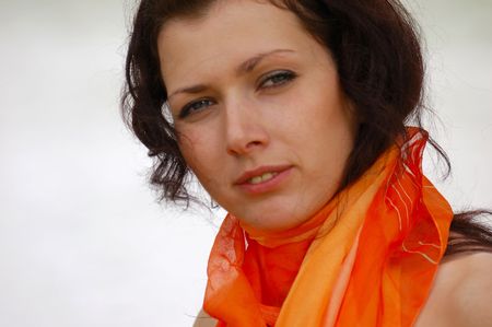 pretty brown-haired typical russian girl with orange scarfの写真素材