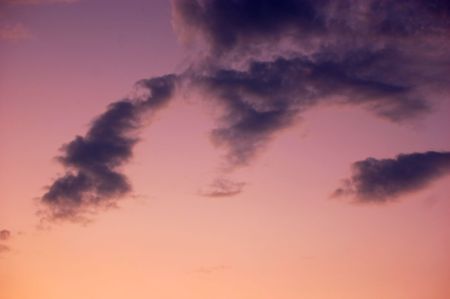 night is falling - violet and pink sky and clouds backgroundの写真素材