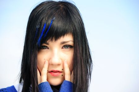 funny young pretty long haired blue-eyed  brunette agains skyの写真素材