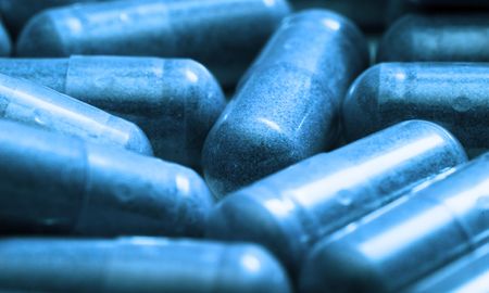 medicine - toned in blue background of film of pillsの写真素材