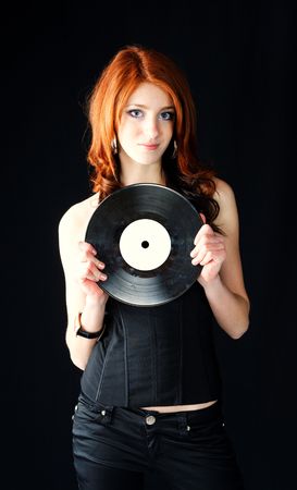 cute young pretty girl in stylish black wear with gramophone recordの写真素材