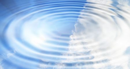 reflection of the blue sky covered with clouds in waterの写真素材