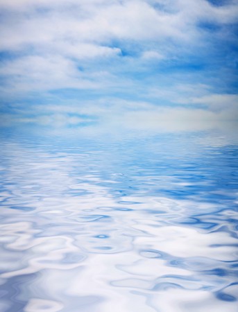 blue sky covered with the film of the clouds and reflection in waterの写真素材