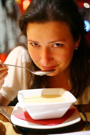 girl eating the soupの写真素材