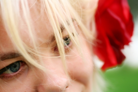 face of pretty blonde with rose in hairsの写真素材