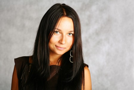 portrait of sexy brunette with good haircut on the grey backgroundの写真素材