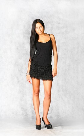 sexy brunette in black dress on gray backgroundの写真素材