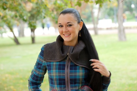 young pretty black haired girl outdoors in autumn
