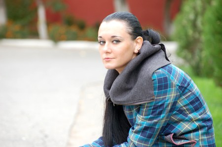 young pretty black haired girl outdoors in autumnの写真素材