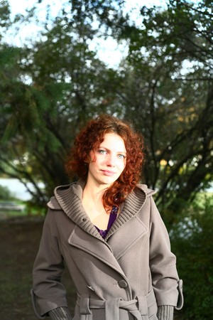 Portrait of a redheaded girl near a tree (autumn colors).の写真素材