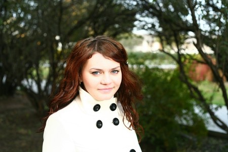 Portrait of a redheaded girl near a tree (autumn colors).の写真素材