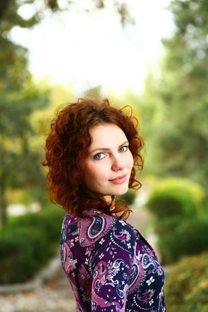Portrait of a redheaded girl near a tree (autumn colors).の写真素材