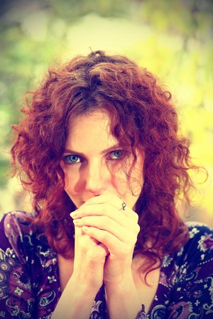 Portrait of a redheaded girl near a tree (split toning).の写真素材