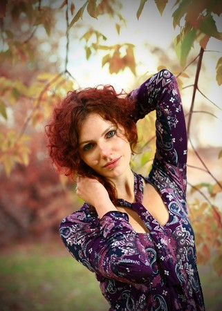 Portrait of a redheaded girl near a tree (split toning).の写真素材