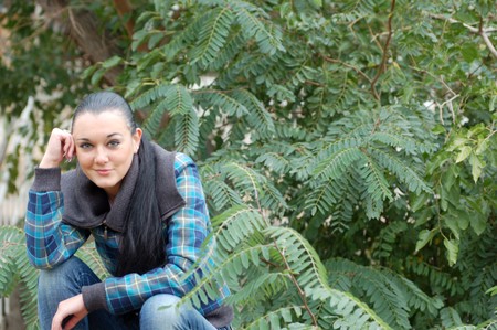 young pretty black haired girl outdoors in autumnの写真素材